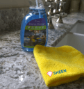 Here is a Granite kitchen worktops cleaning product on a granite countertop with a microfiber cloth