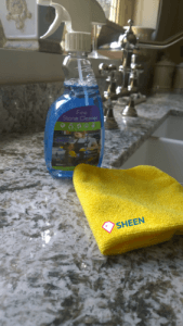Here is a Granite kitchen worktops cleaning product on a granite countertop with a microfiber cloth